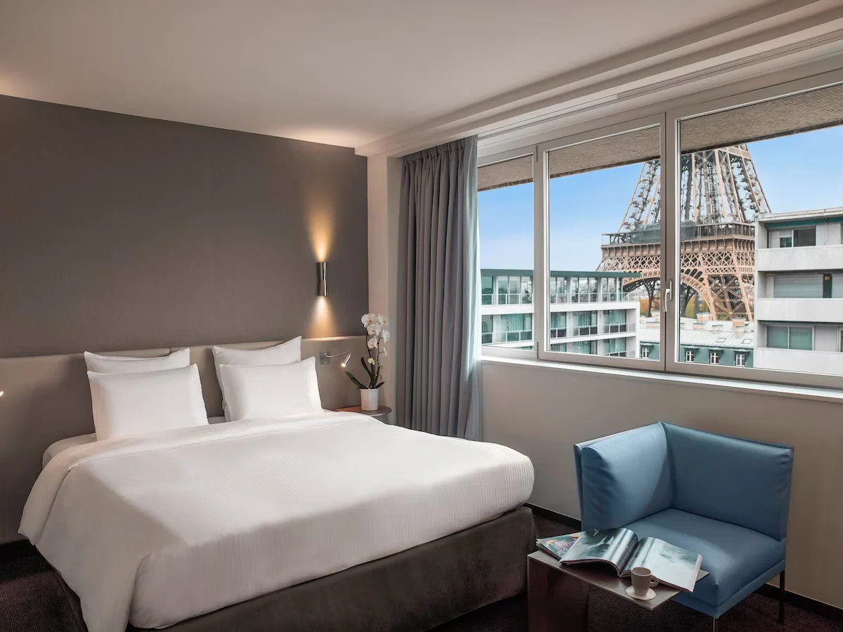 Guestroom at Pullman Paris Tour Eiffel with the Eiffel Tower visible through the window